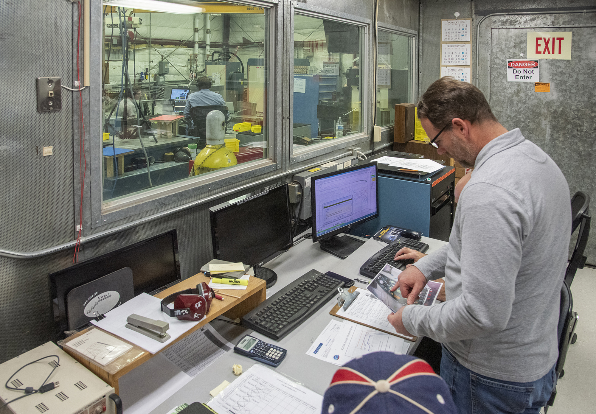 Engineers monitor data during vibration testing of a cruise motor controller for the X-57 Maxwell.