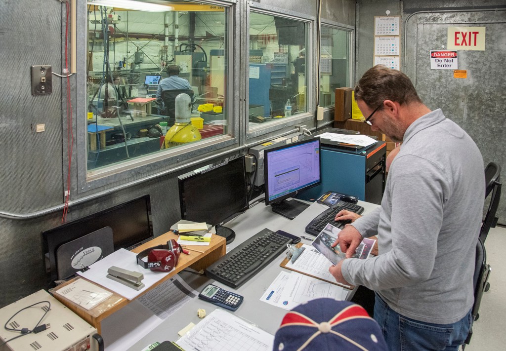 Engineers monitor data during vibration testing of a cruise motor controller for the X-57 Maxwell.
