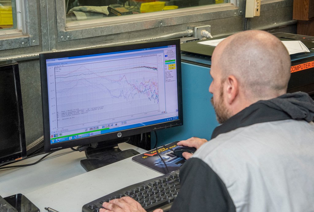 Engineers monitor data during vibration testing of a cruise motor controller for the X-57 Maxwell.