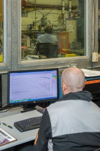 Engineers monitor data during vibration testing of a cruise motor controller for the X-57 Maxwell.