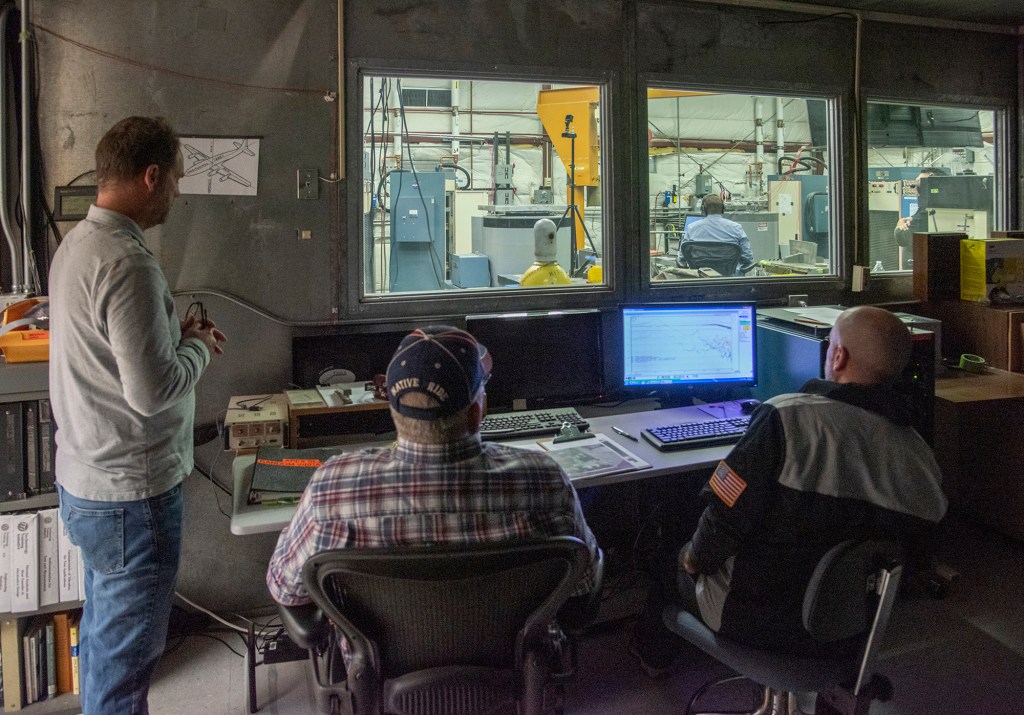 Engineers monitor data during vibration testing of a cruise motor controller for the X-57 Maxwell.