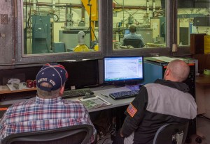 Engineers monitor data during vibration testing of a cruise motor controller for the X-57 Maxwell.