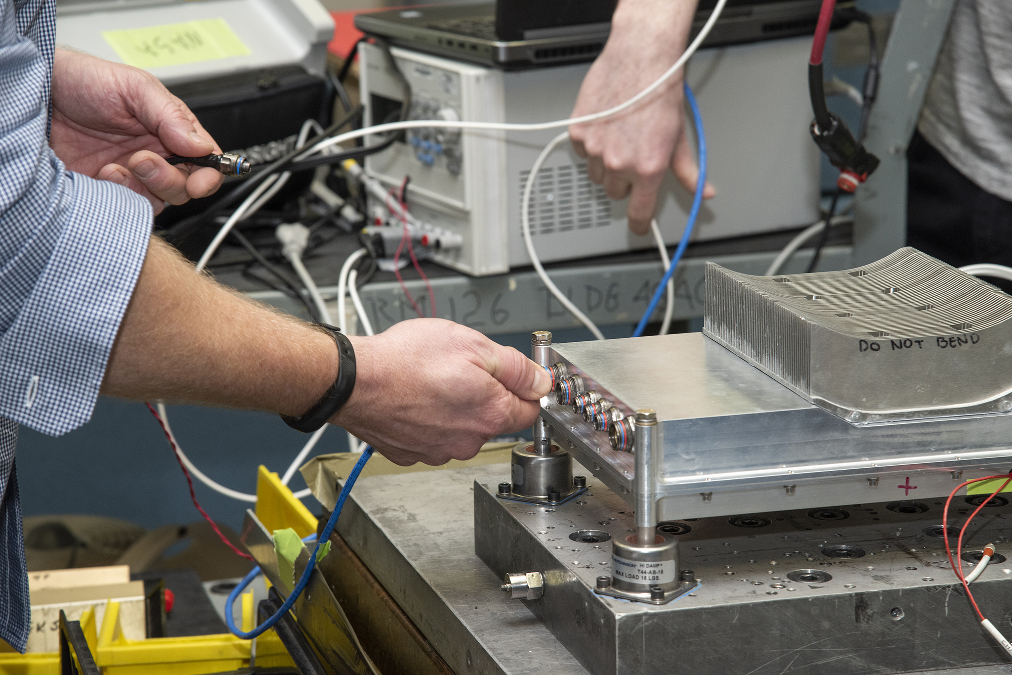 Engineers prepare a cruise motor controller for the X-57.