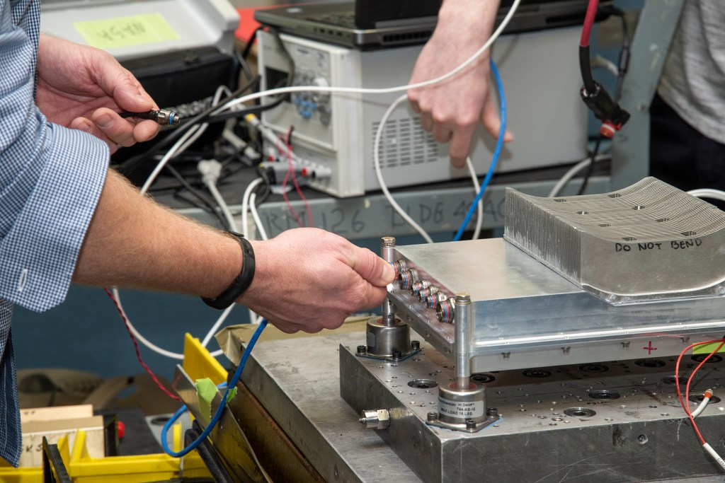 Engineers prepare a cruise motor controller for the X-57.