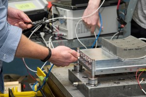Engineers prepare a cruise motor controller for the X-57.