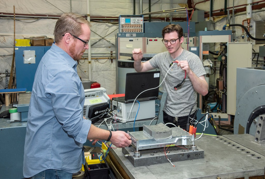 Engineers prepare a cruise motor controller for the X-57.