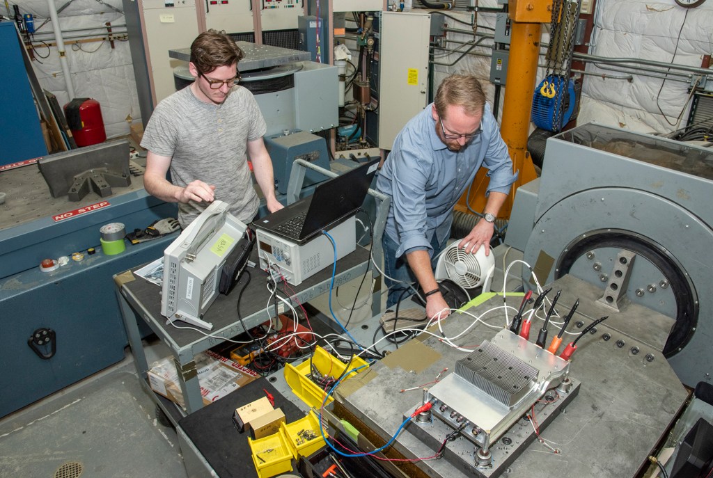 Engineers prepare a cruise motor controller, planned to be used on NASA?s all-electric X-57 Maxwell.