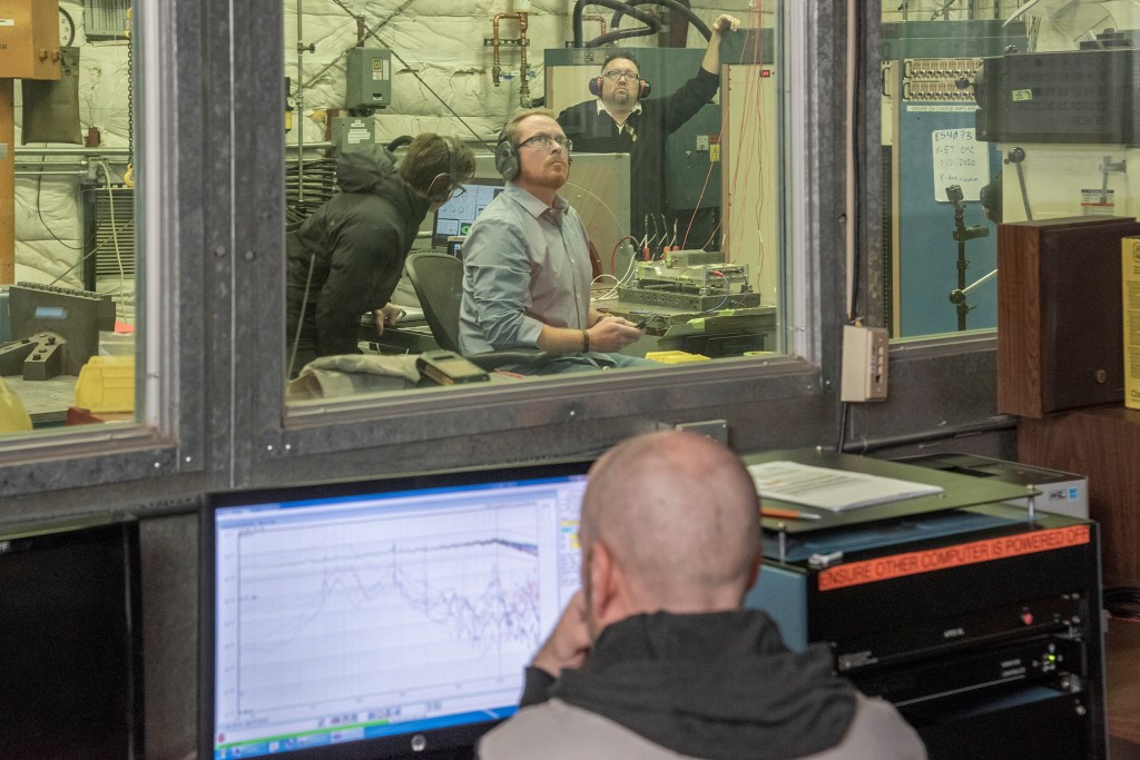 Engineers monitor data during vibration testing of a cruise motor controller for the X-57 Maxwell.