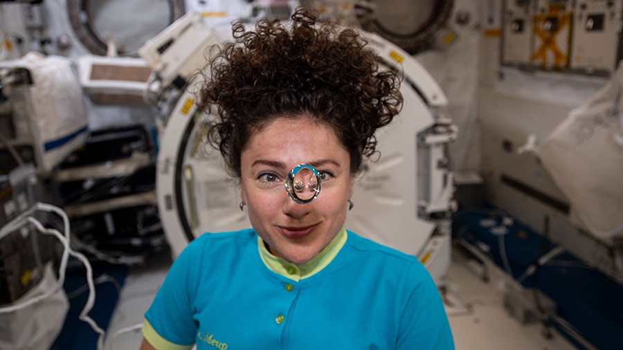 NASA astronaut Jessica Meir observes a floating sphere of water