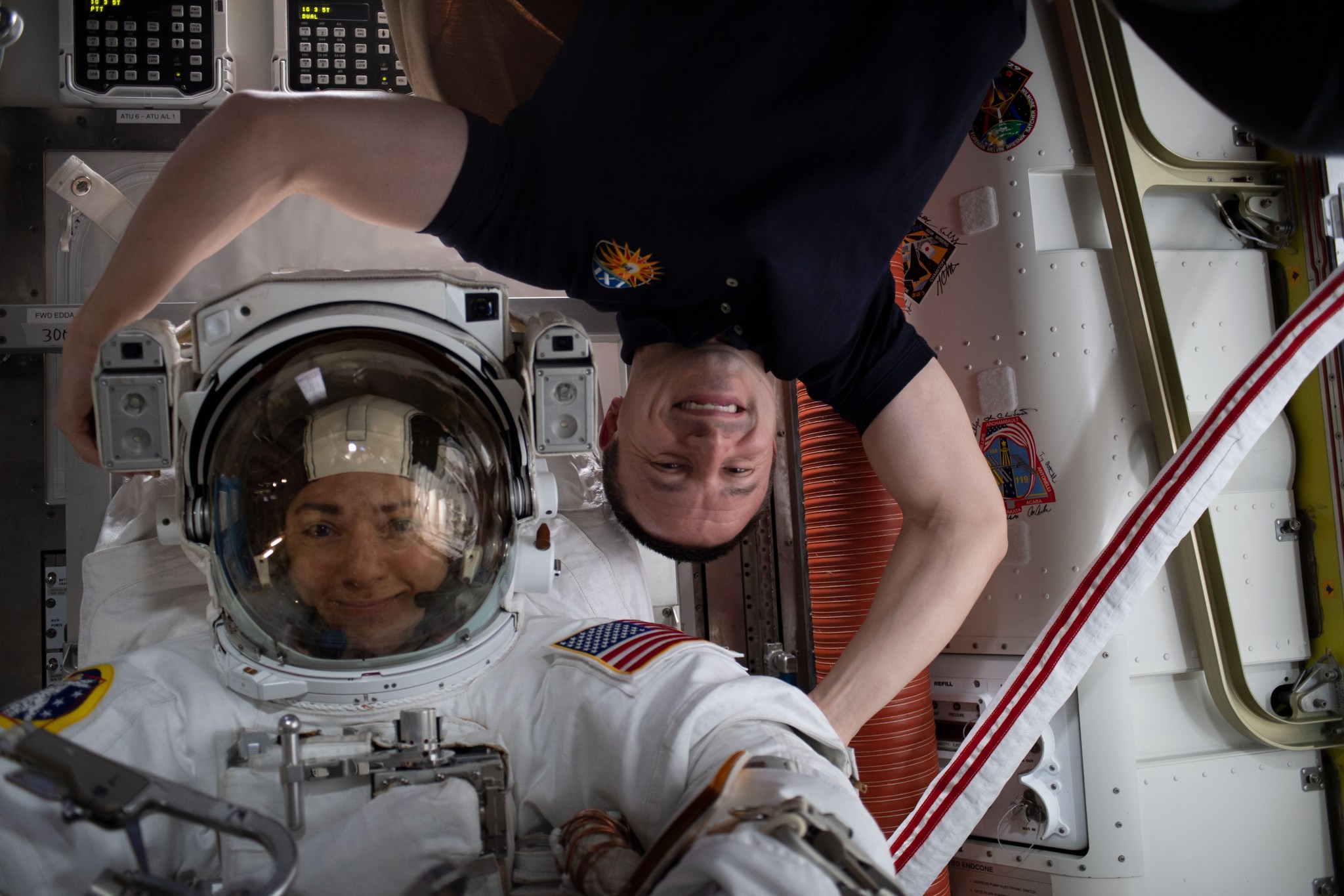 NASA astronauts Jessica Meir, left, and Andrew Morgan pose for a photo in the Quest Airlock prior to a spacewalk on Oct. 18, 201