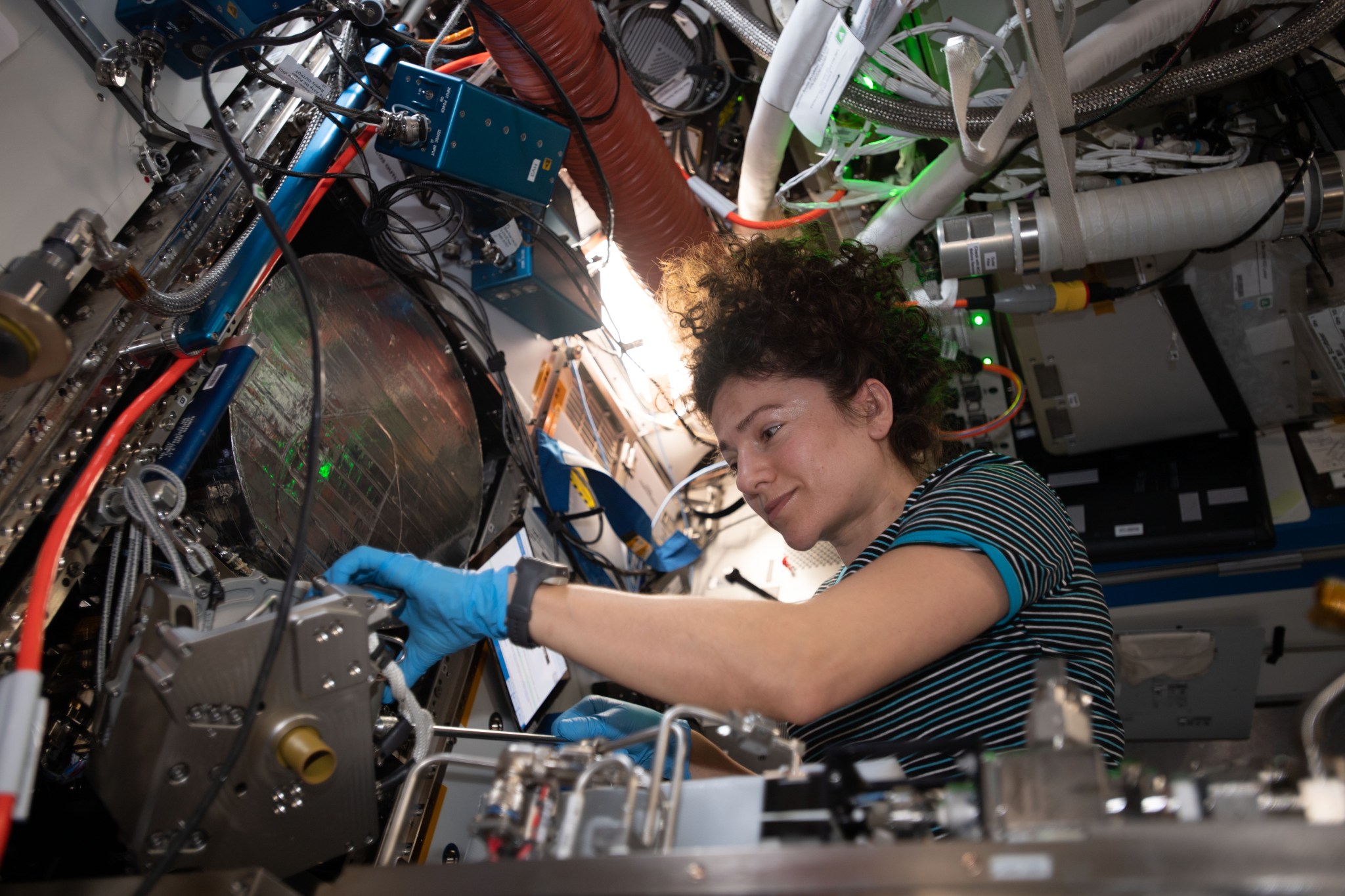 NASA astronaut Jessica Meir works on works on orbital plumbing tasks inside the Tranquility module's Life Support Rack