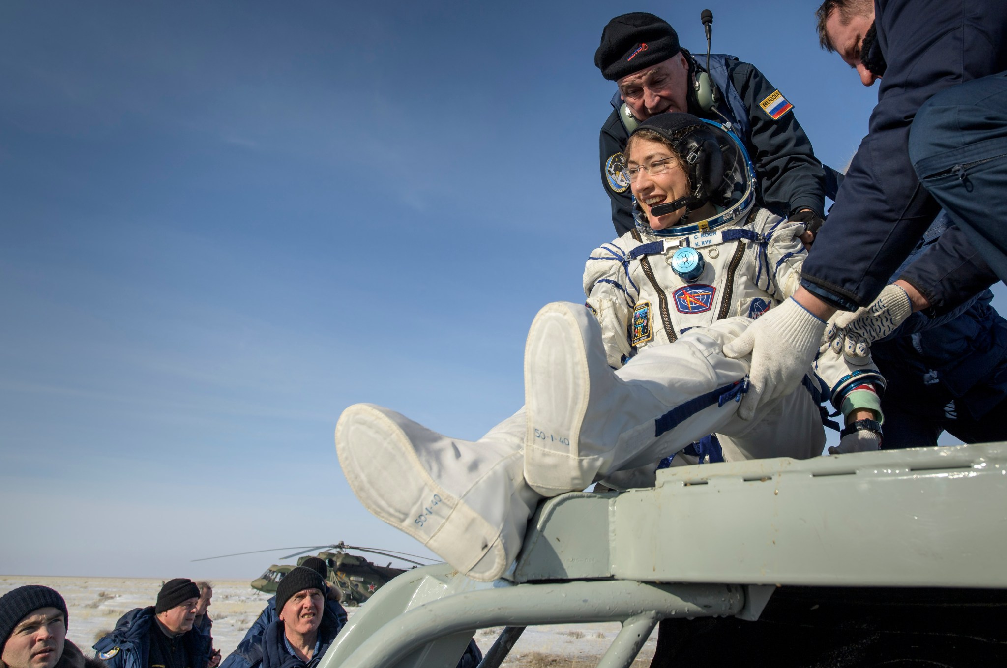 NASA astronaut Christina Koch is helped out of the Soyuz capsule after returning from the space station on Feb. 6, 2020.