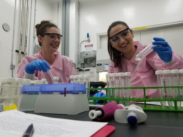 image of scientists preparing their investigation for flight in a laboratory setting