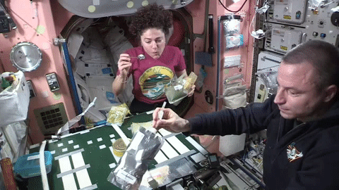 NASA astronauts Jessica Meir and Andrew Morgan share dinner aboard the space station.