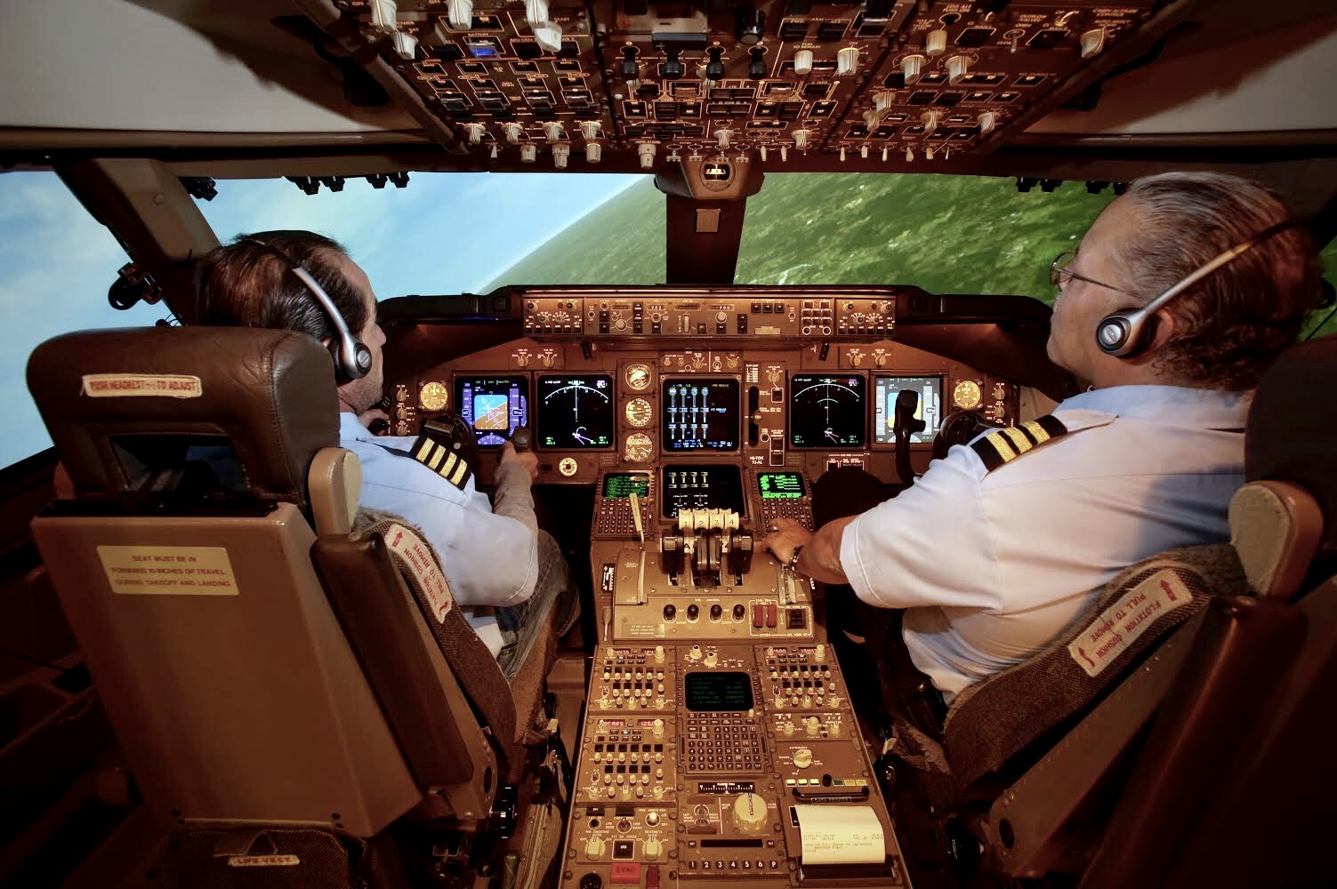 Two pilots in the cockpit of a flight simulator