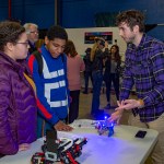 Alexander Summers, right, an engineer at NASA’s Marshall Space Flight Center, talks with Amber George, left, and Steven Hughes.