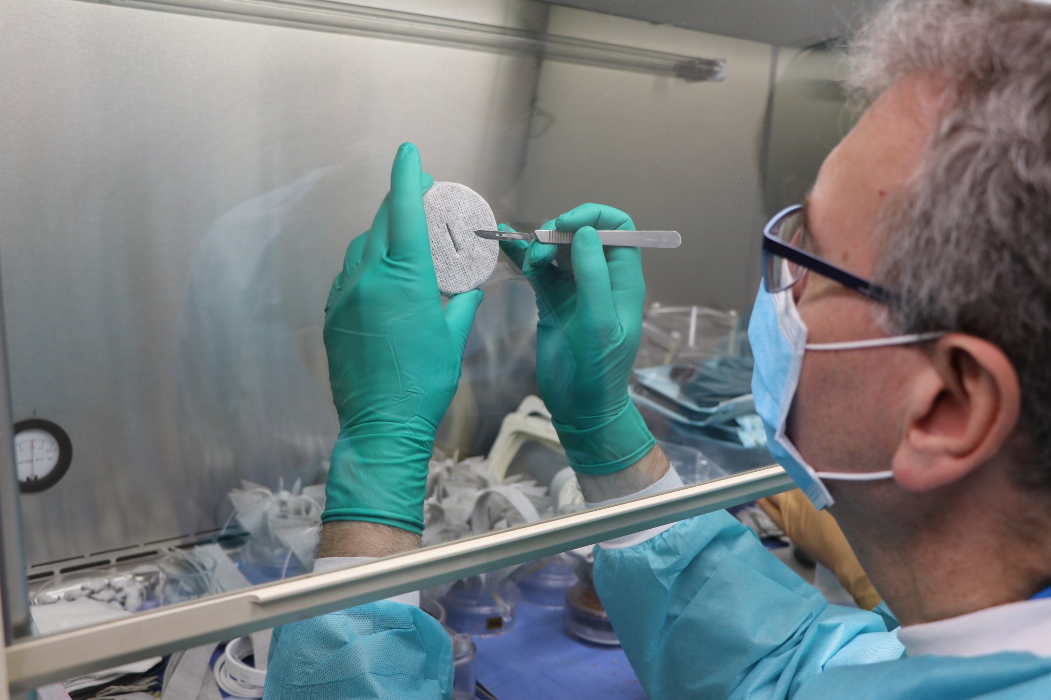 Kennedy Space Center employee Jeff Richards assembles PONDS hardware components inside the Space Life Sciences Laboratory. 