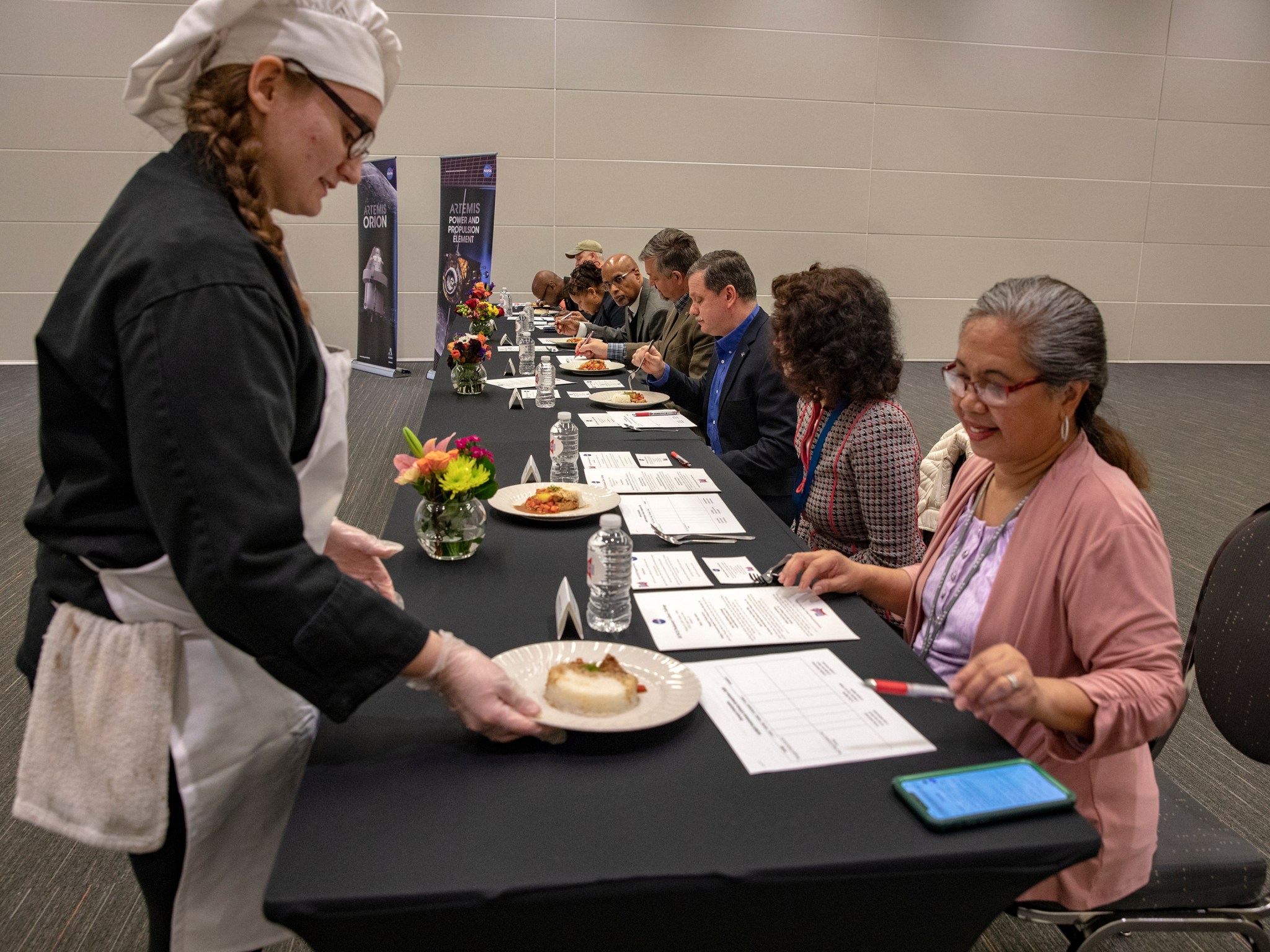 A team member of the Bridging Communities Regional Career and Technical Center presents their dish to a judge.