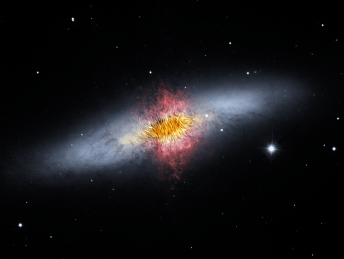 Image of Cigar Galaxy with its magnetic field shown as streamlines over red outflow, yellow dust, and black and white stars