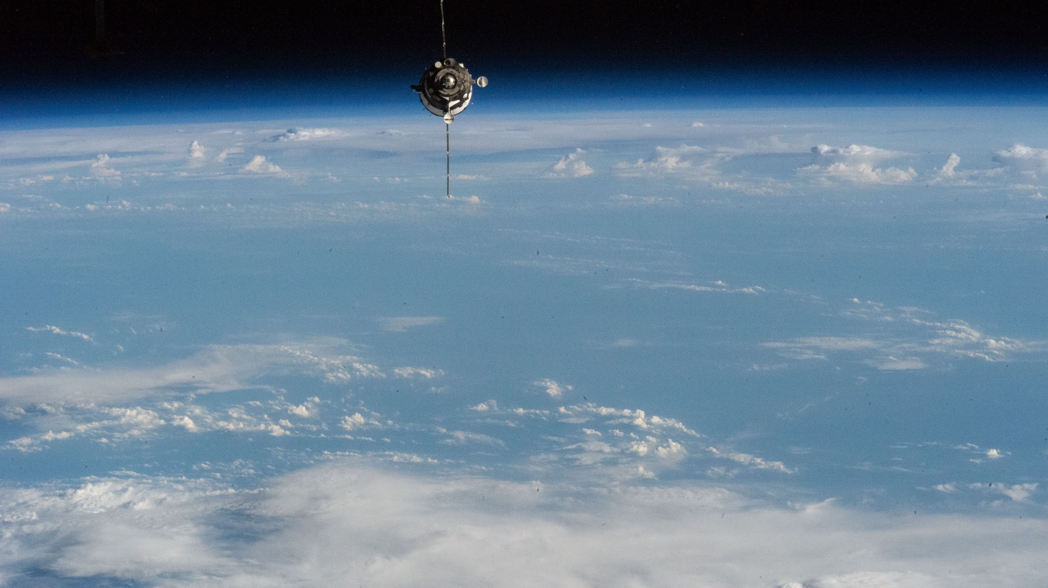 soyuz spacecraft in orbit above the earth
