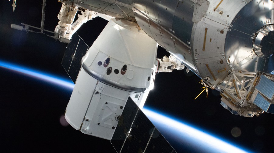 The SpaceX Dragon resupply ship is pictured attached to the Earth-facing port on the International Space Station's Harmony module.