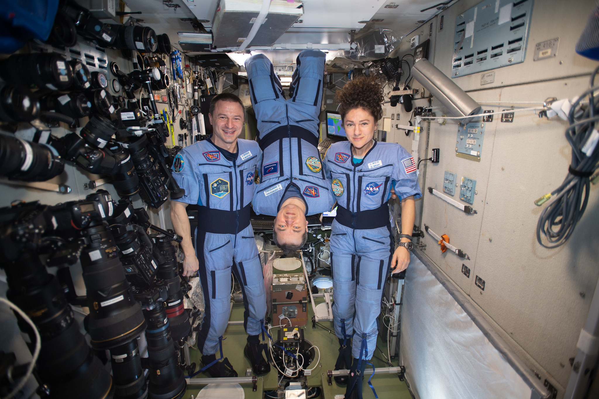 NASA Flight Engineers Andrew Morgan and Jessica Meir flank Expedition 62 Commander Oleg Skripochka of Roscosmos