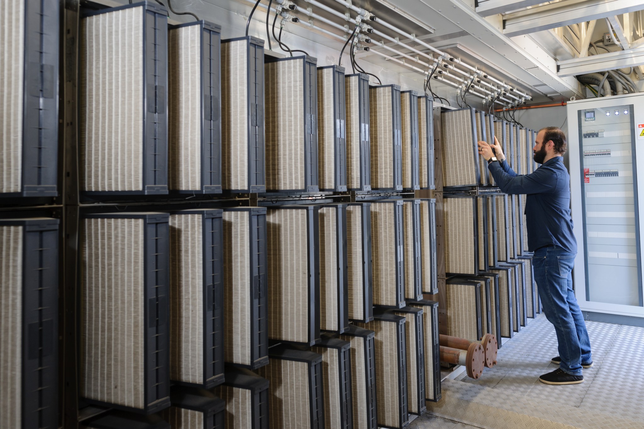 A technician replaces filters in the Modular Supercomputing Facility