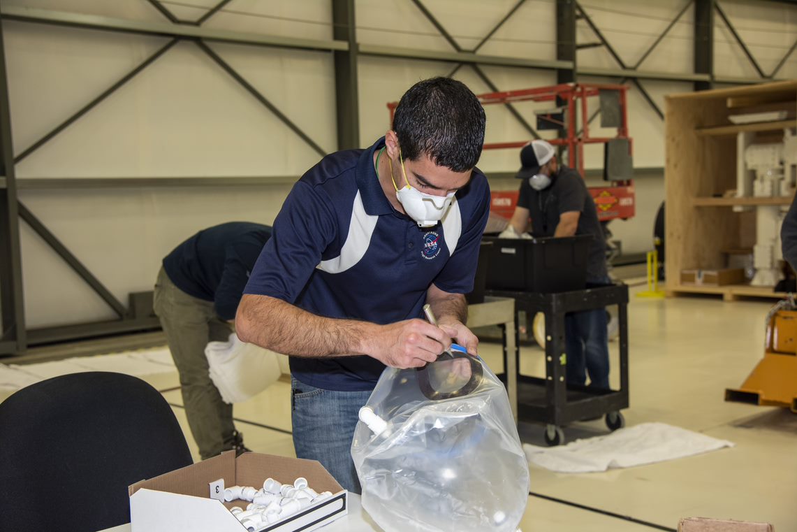 An employee works on the Aerospace Valley Positive Pressure Helmet,