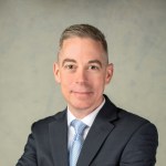 A smiling portrait of Kevin Coggins.