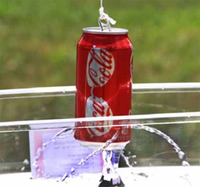 Hanging soda can has water flowing out of holes from its sides