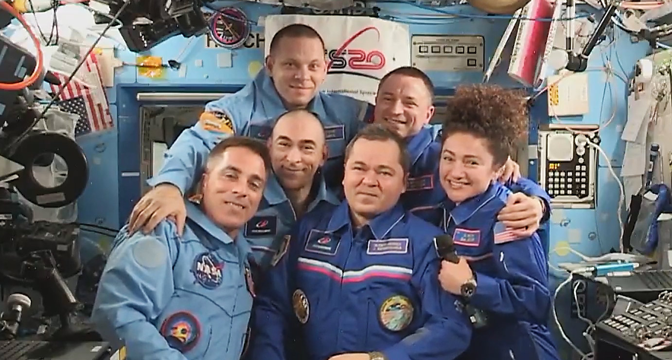 The six station crewmembers join each other for a group hug
