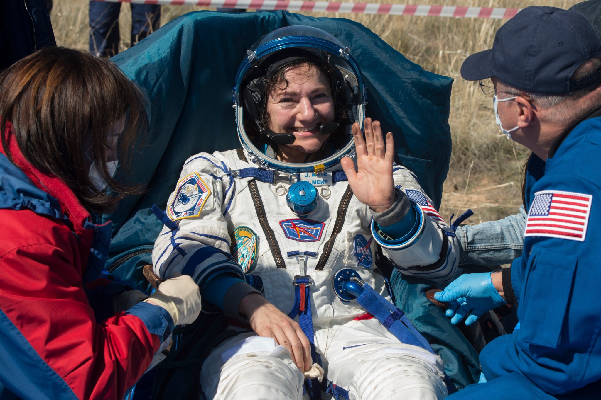 astronaut Jessica Meir waves from outside the Soyuz MS-15 