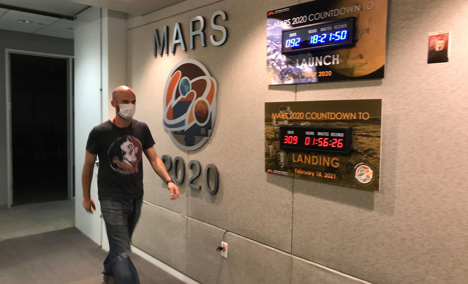 Ian Clark walks past mission countdown clocks