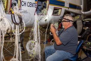 Technician David Johnson works on rewiring the high-altitude ER-2 aircraft’s fixed nose and cockpit.