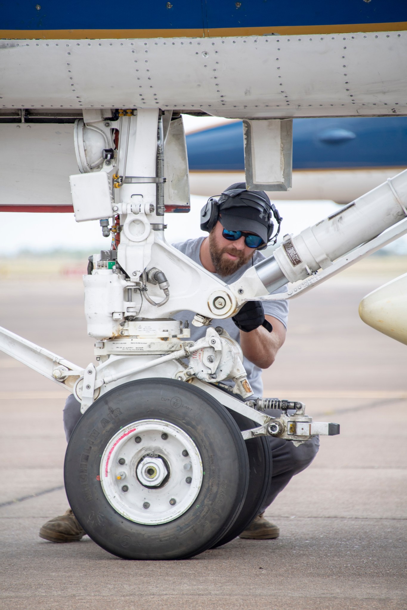 Armstrong Flight Research Center technician Jack Ford works on the nose wheel of a NASA F/A-18