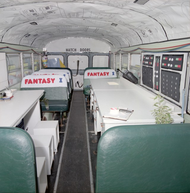 School bus interior decorated like a space shuttle crew module.