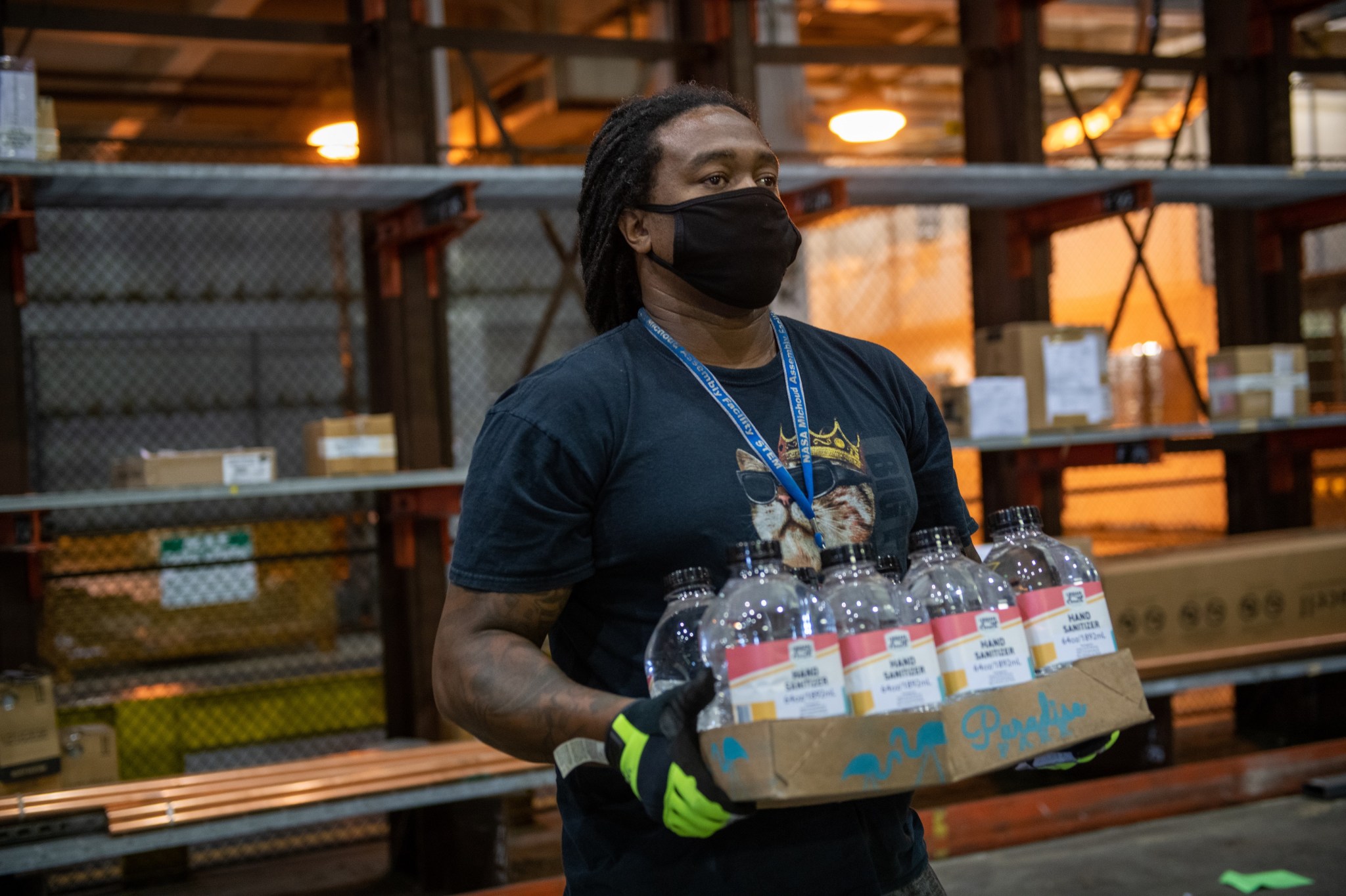 A Michoud employee prepares hand sanitizer stations May 18 as the facility transitions to Stage 3.