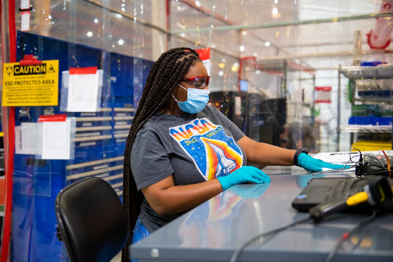 Boeing’s Jade Mitchell cleans a surface as NASA’s Michoud Assembly Facility transitions to Stage 3.