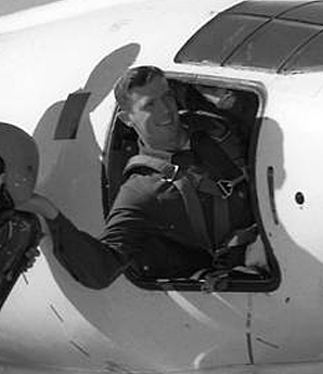 Man posing in cockpit.