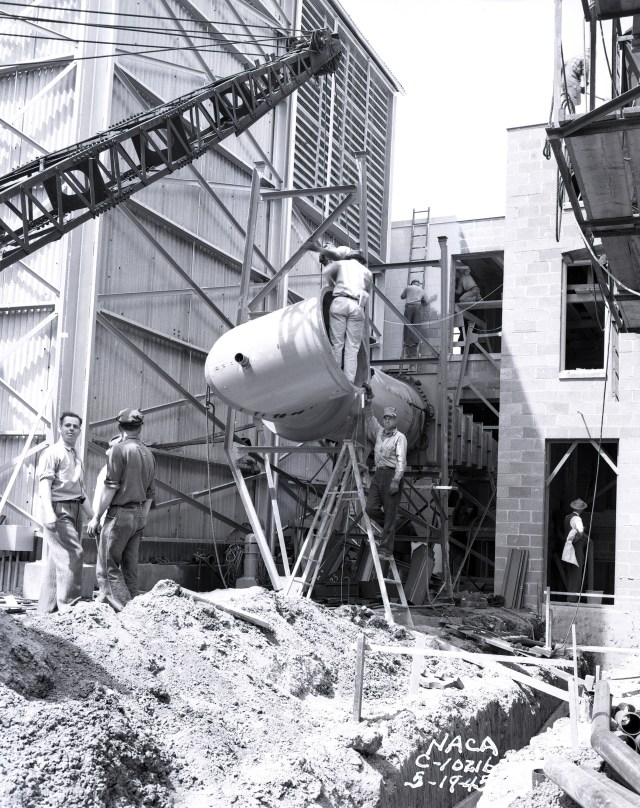A construction crew at the building site where a wind tunnel is being installed.