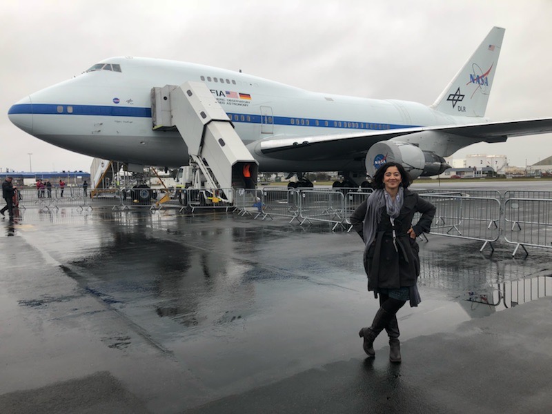 Woman (Hina) standing in front of the SOFIA aircraft.
