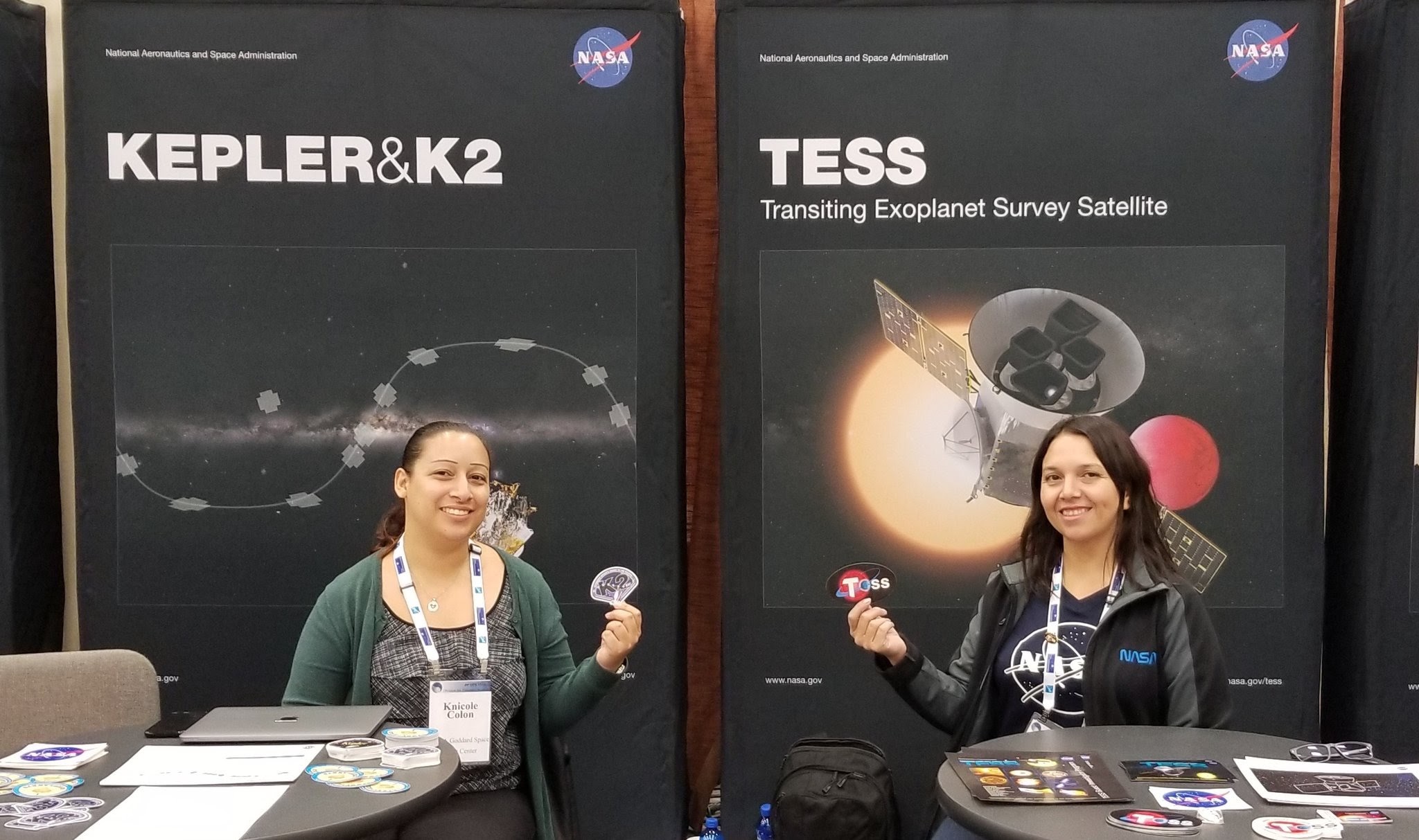 NASA astrophysicists Knicole Colon and Elisa Quintana with stickers from some of NASA's exoplanet missions. 