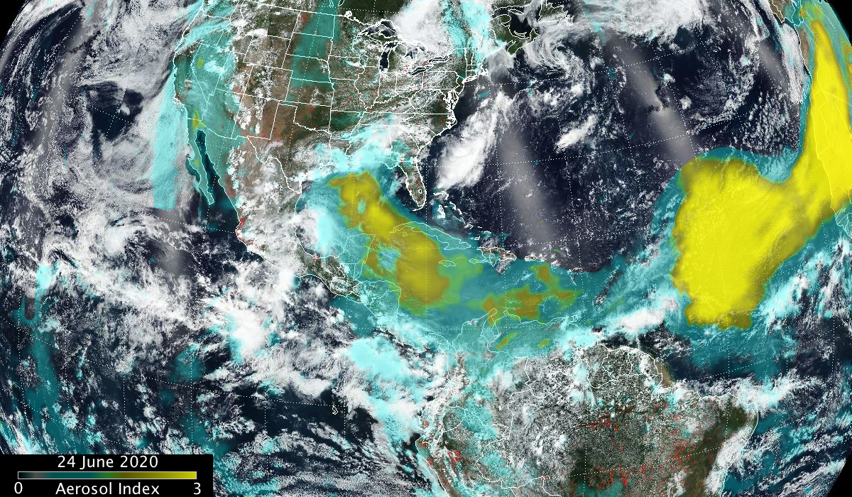 Satellite image of the Americas, all of the U.S. and the northern part of South America, Clouds are visible throughout, and the yellow and blue aerosol index is overlaid on top of "true color" imagery. 