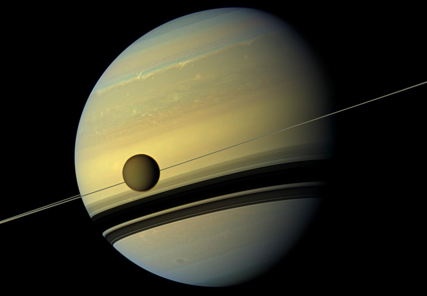 Titan is seen here as it orbits Saturn