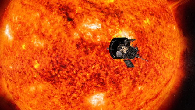 An illustration shows the Parker Solar Probe in front of the Sun. The Sun appears red and orange with bright yellow active regions.
