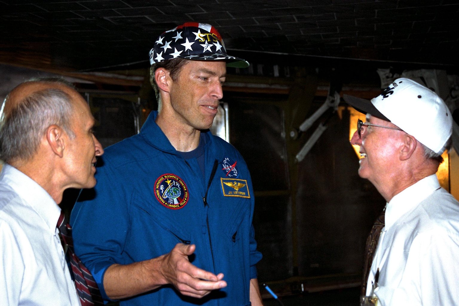 Jim Wetherbee, center, speaks with Shuttle Operations Director Bob Sieck, left, and Launch Director Jim Harrington. 