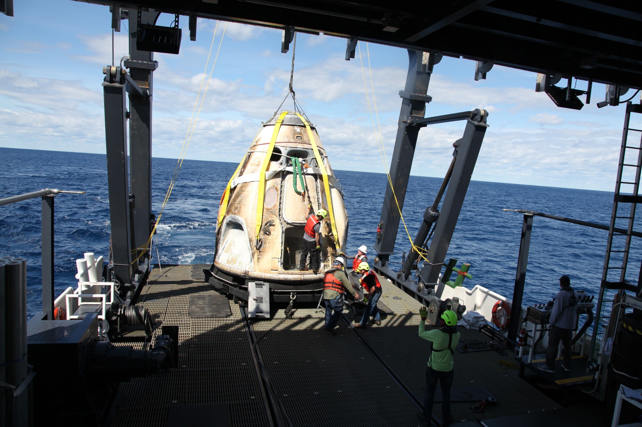 SpaceX’s Crew Dragon is loaded onto the company’s recovery ship, Go Searcher, in the Atlantic Ocean on March 8, 2019.