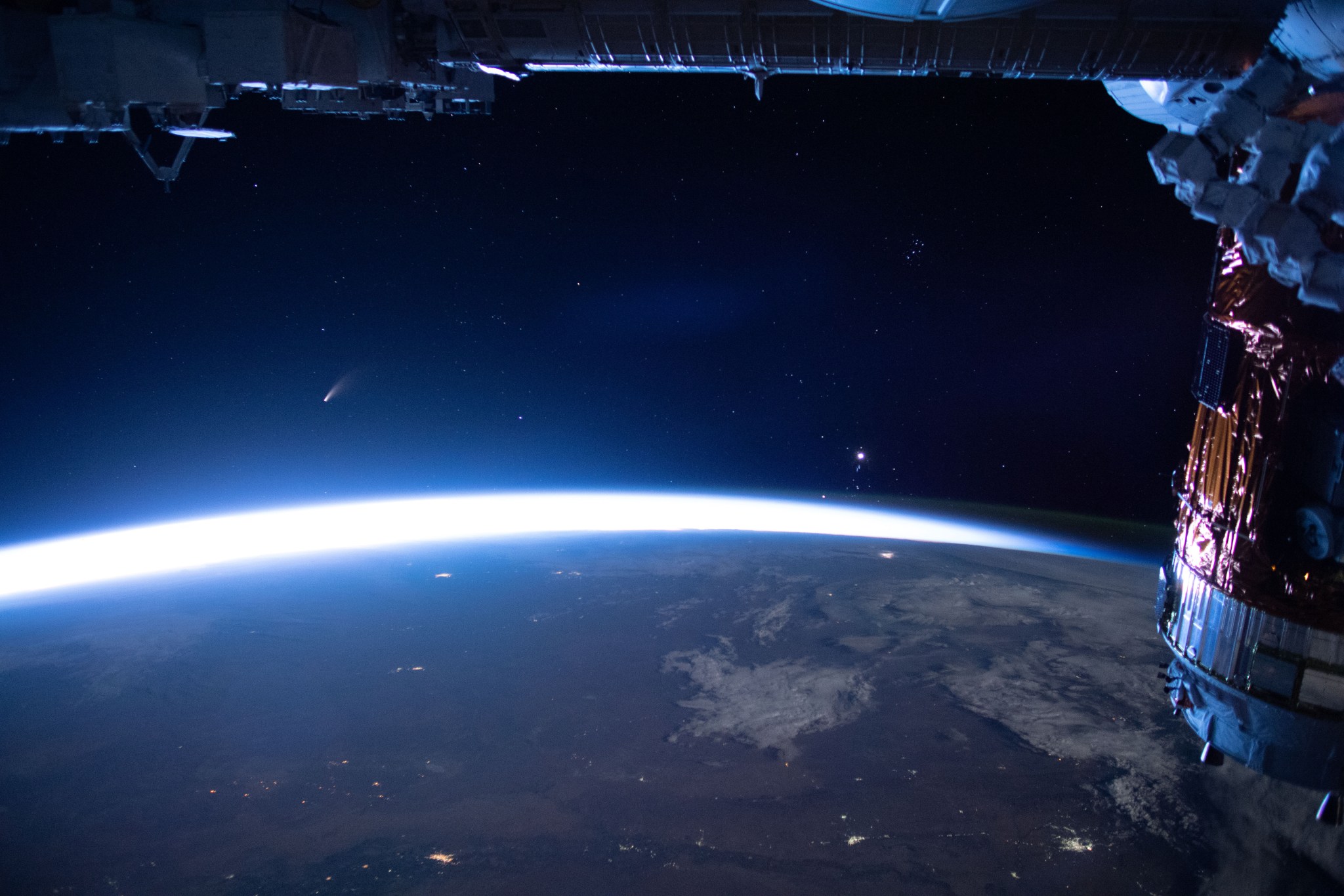 An International Space Station camera captures the streaking comet NEOWISE, left, on July 5. 