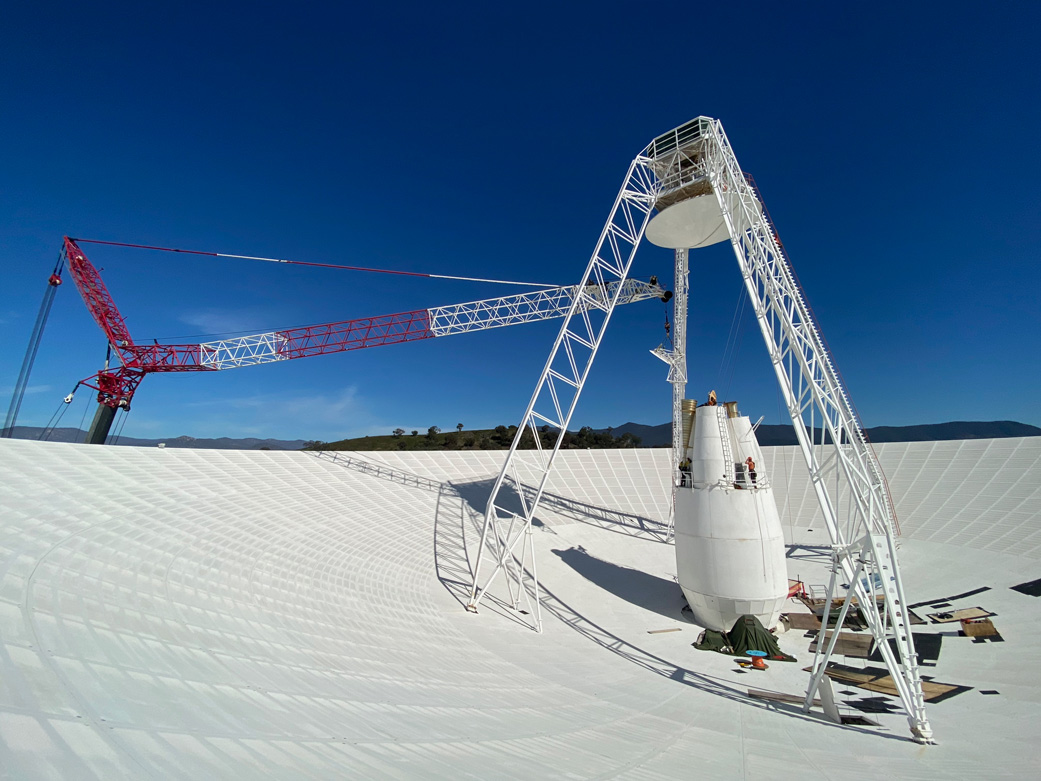 Workers perform upgrades on the central cone of the Deep Space Network's Deep Space Station 