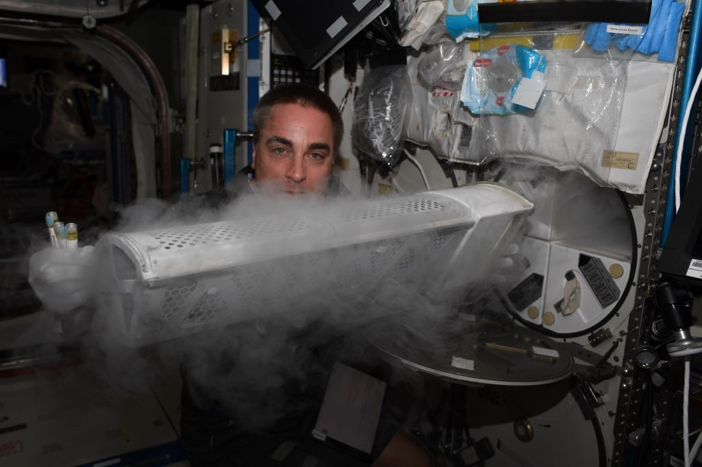 astronaut Chris Cassidy placing a Food Physiology sample into MELFI